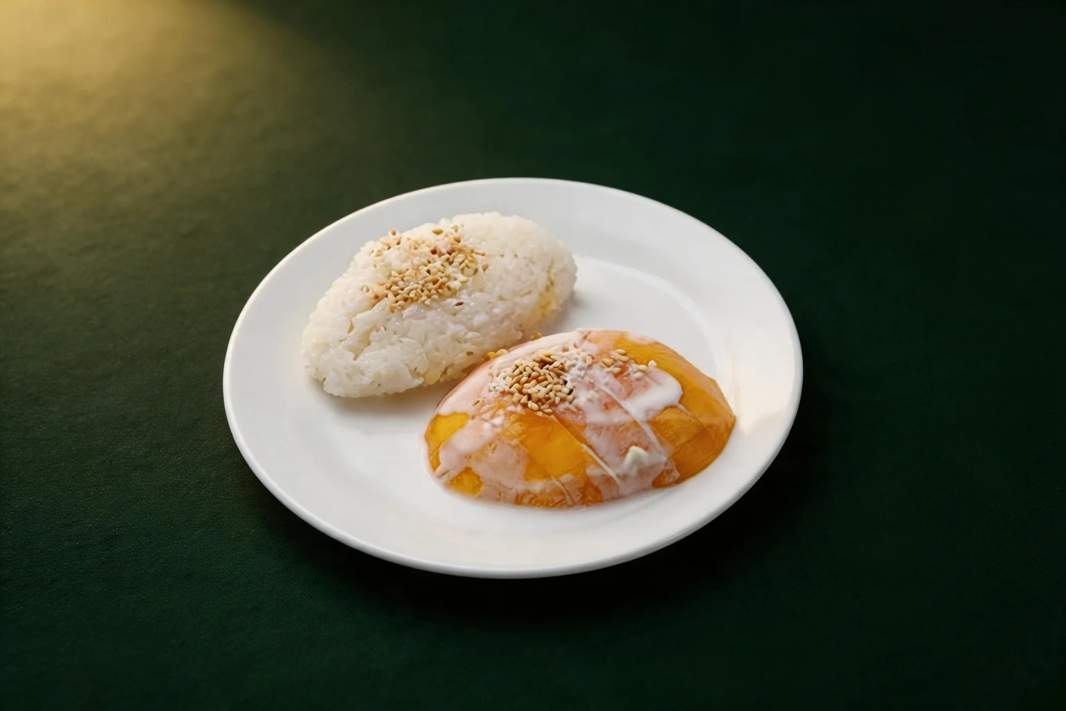 Sticky rice and mango on a white plate, dark green background